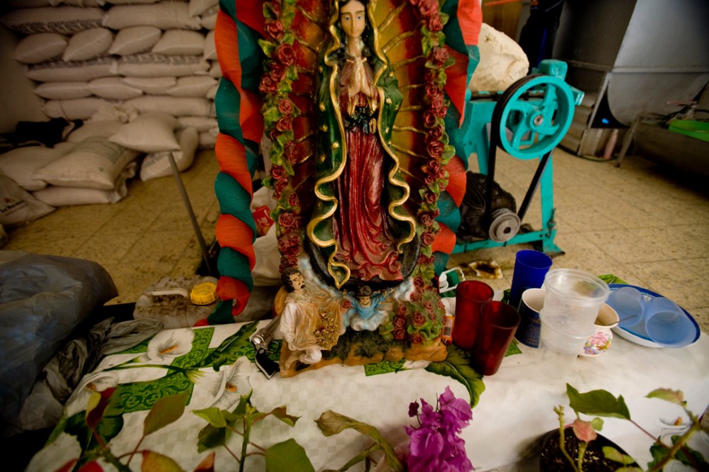 guad_morelia2_mres A Virgen de Guadalupe in a bakery in Morelia, Mexico has money and a small toy gun at her feet.